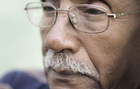 Starejši moški s temno kožo in vidnimi nazolabialnimi gubami